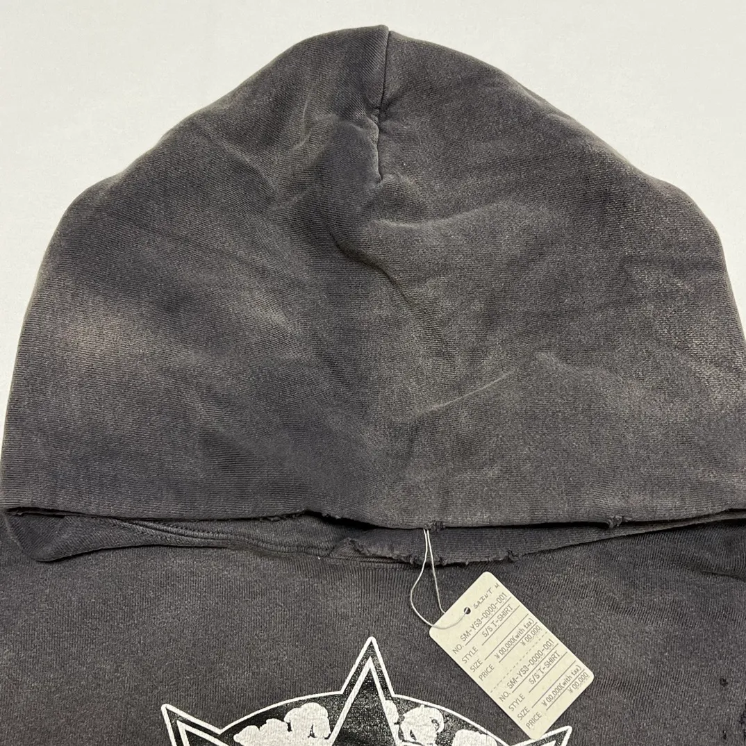 DENIM TEARS x SAINT Mxxxxxx SAINT TEARS Hoodie/BLK Five-pointed star cotton hole-in-the-dark distressed hoodie, washed black S-XL Assute dyeing, whole piece sprayed with horse fade/horse weight, co-branded main mark/cotton wash mark/cherub mark, many hanging holes on the front and rear panels, the original version has the same loose fit